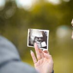 A man looking at a photo of an ultrasound.