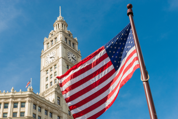 4 - Edwards Law An image of the U.S. flag blowing in the wind in front of a government building.
